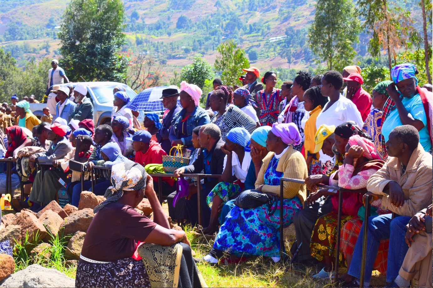 Large community gathering outdoors in rural Kenya