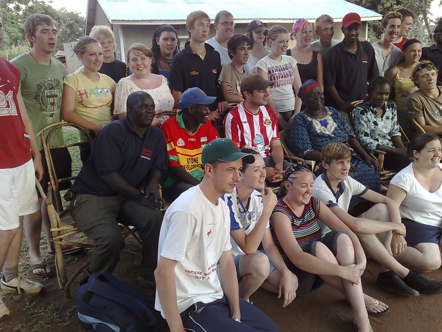 International volunteers and members of a Kenyan host community gathered together outdoors